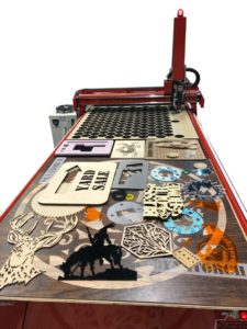 Laser-cut wooden craft pieces on CNC table