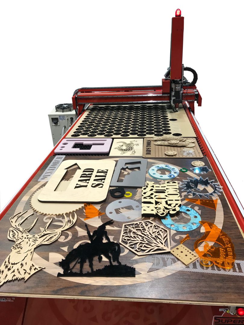 Laser-cut wooden craft pieces on CNC table Laser-cut wooden craft pieces on CNC table